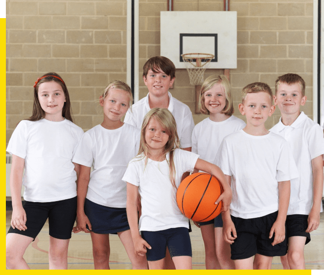 A group of children in white shirts and black shorts.