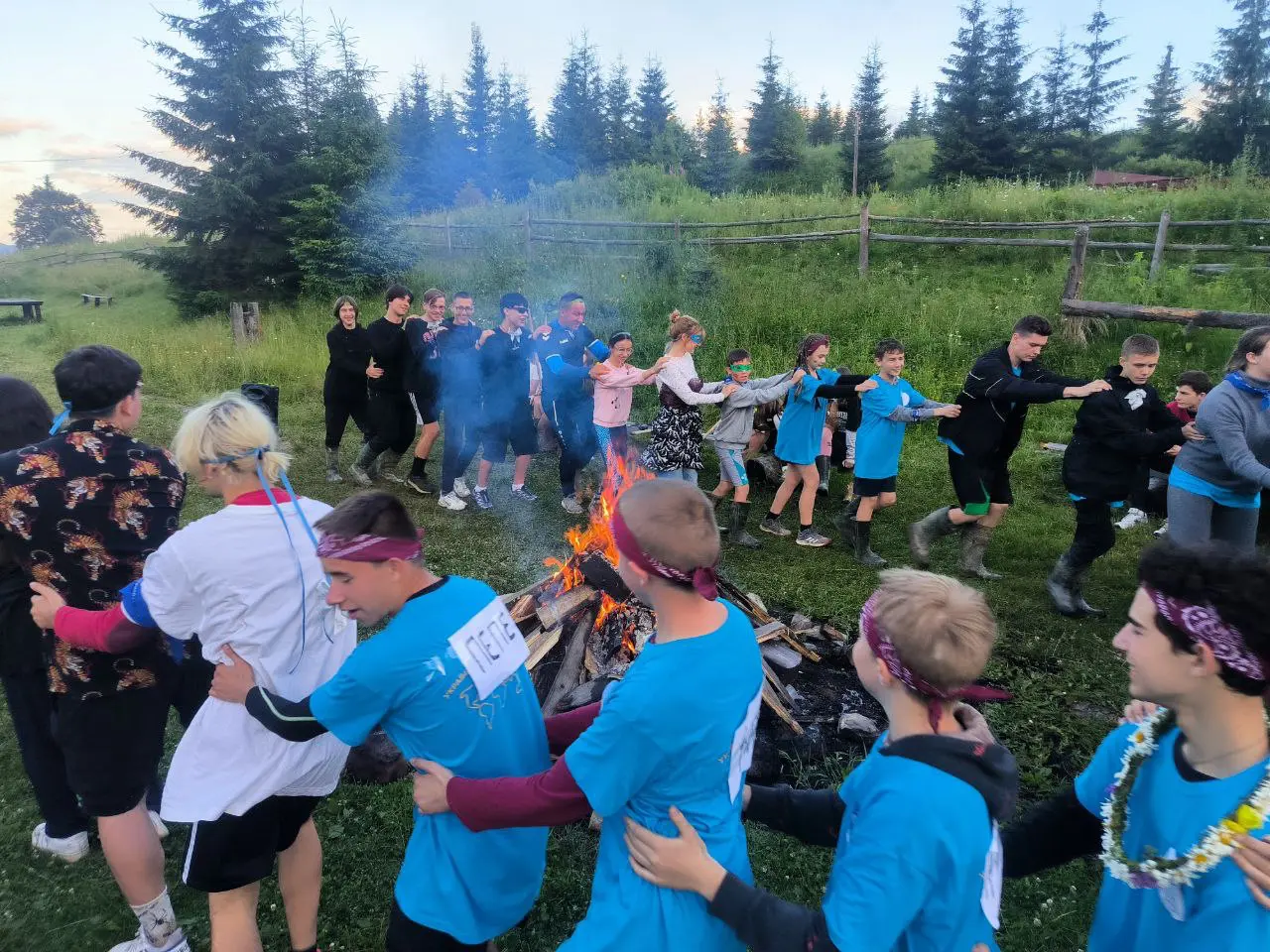 A group of people standing around a fire.